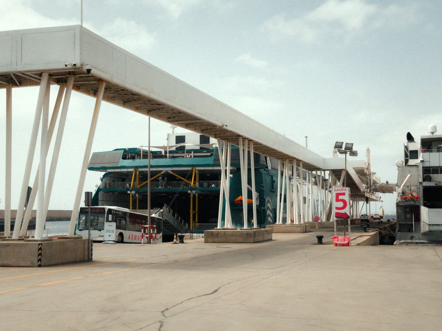 adani ports shares — Ferry and terminal structures at a Canary Islands port, Spain, under a bright day sky.