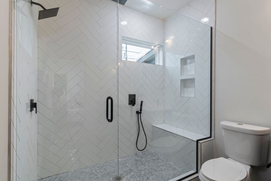 bathroom renovation cost — Elegant bathroom featuring a sleek walk-in shower and contemporary design.