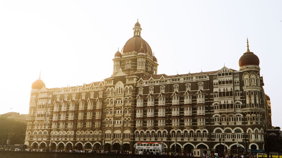 india tourism mou — Beautiful view of the iconic Taj Mahal Palace Hotel in Mumbai during a serene sunrise.
