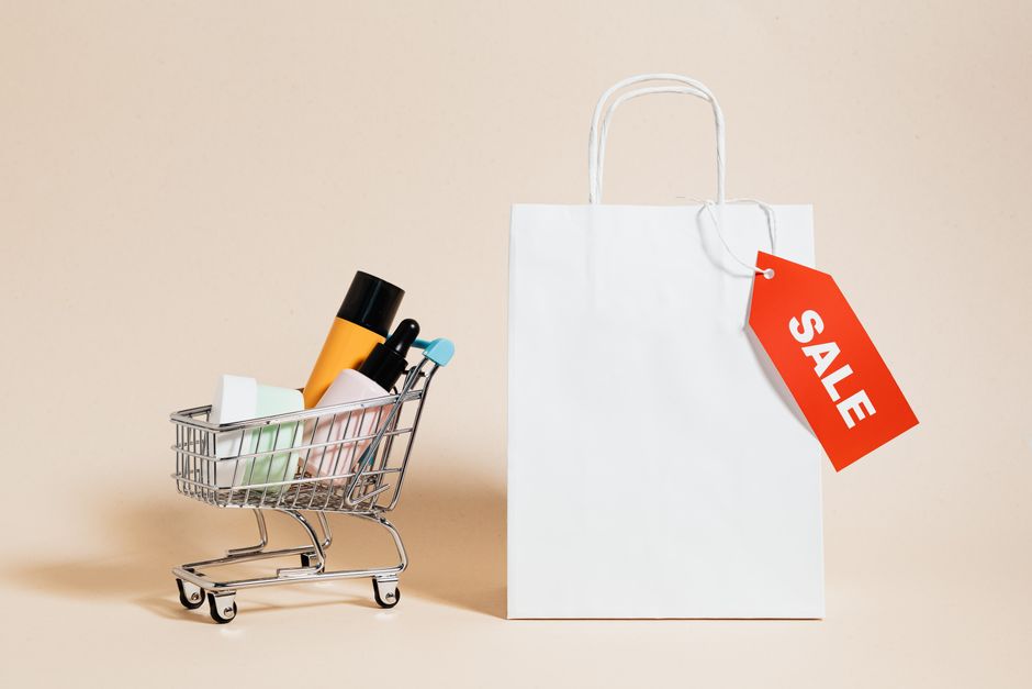 nykaa revenue 2026 — Minimalist image featuring a shopping cart with products and a sale-tagged bag.
