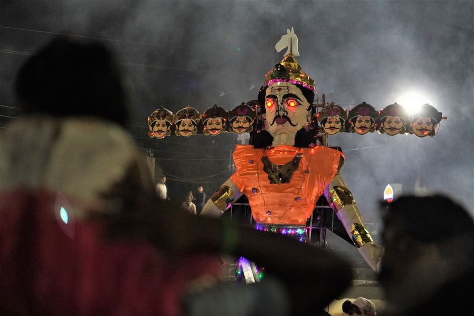 ramayana music deal — A dramatic nighttime Dussehra festival scene featuring a large illuminated Ravana effigy.
